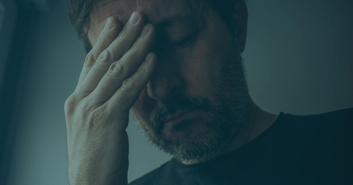 Stressed man rubbing foreheads