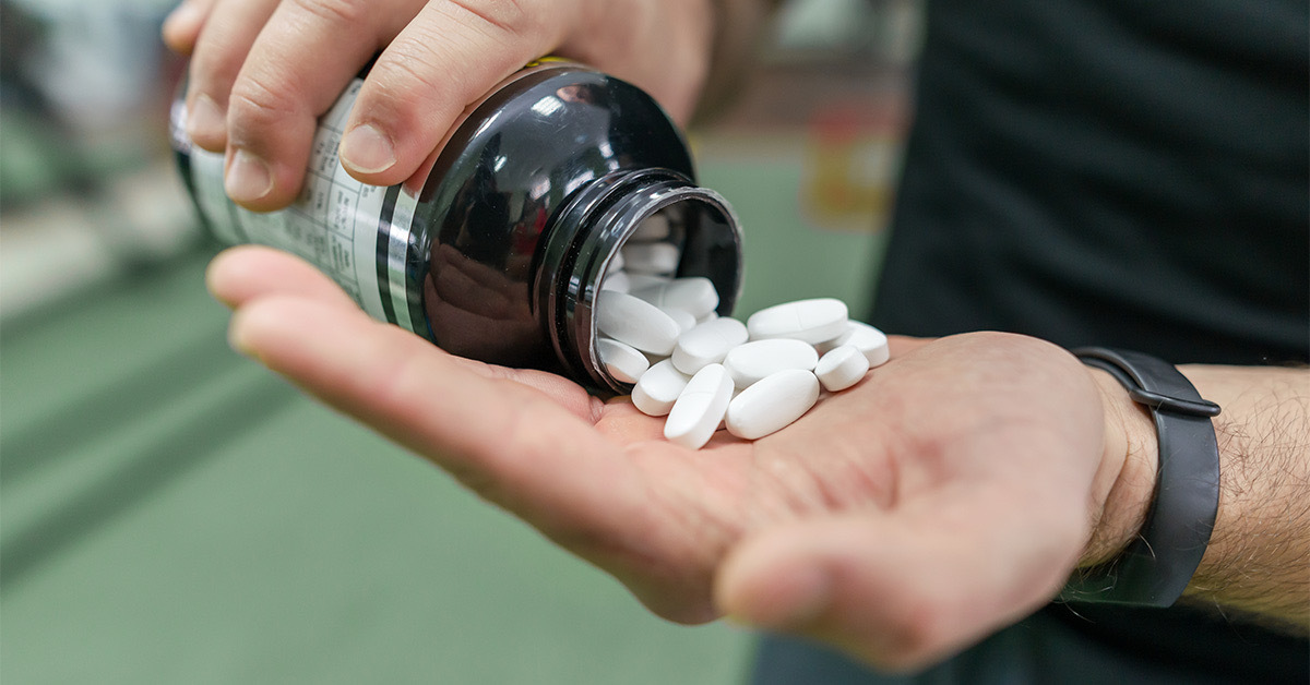 Pouring white pills into your palm